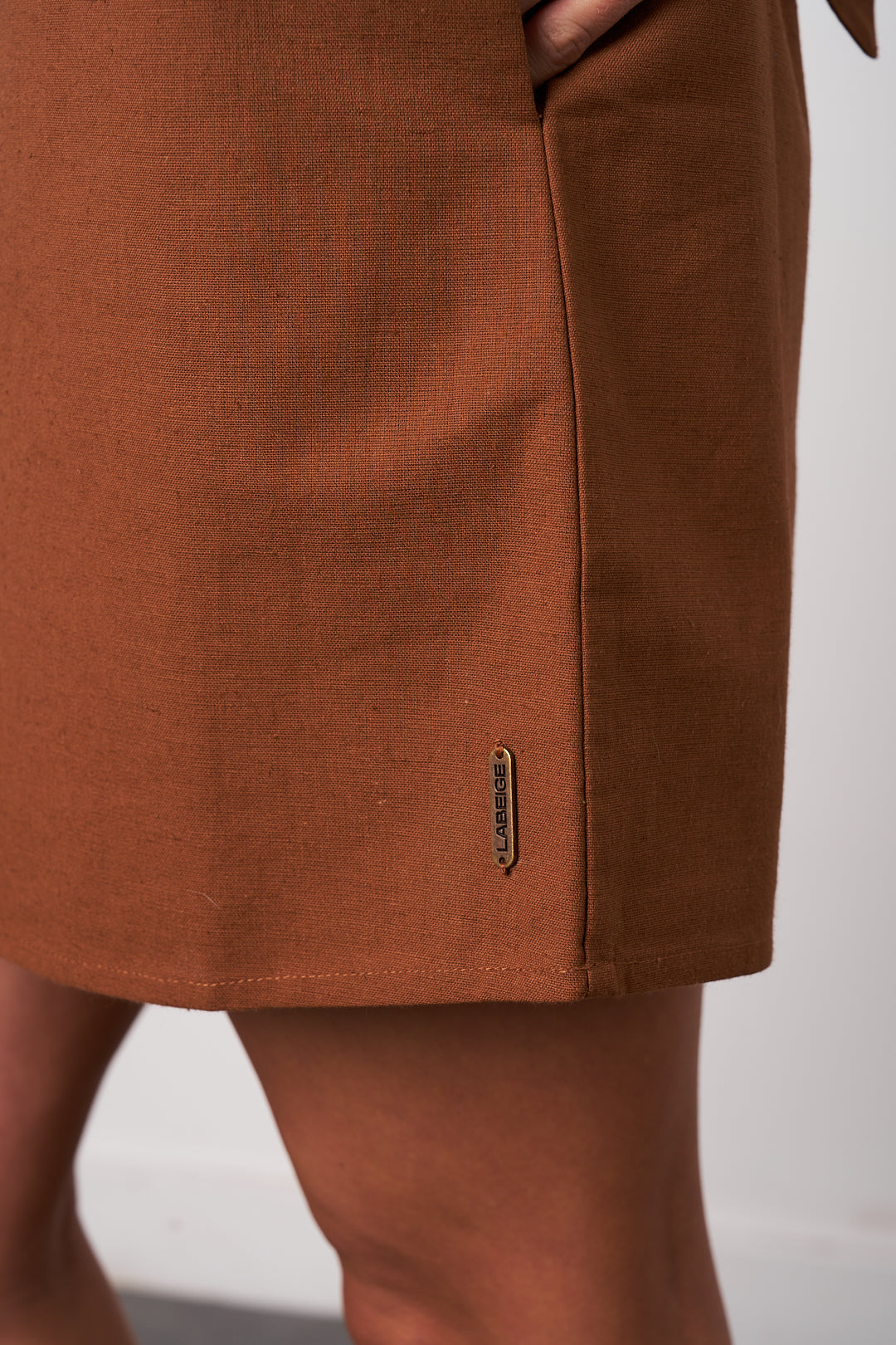 Brown skirt with a brand logo on a white background