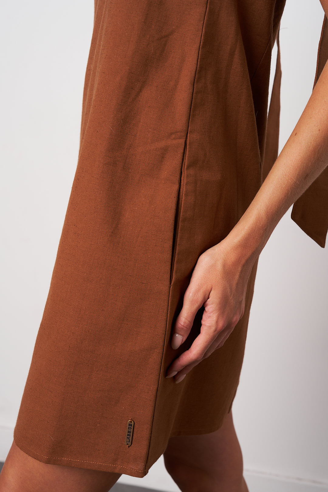 Brown shorts with a visible brand logo on a white background