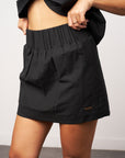 Black shorts worn by a person against a neutral background