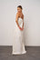 Woman wearing a white slip dress against a plain background